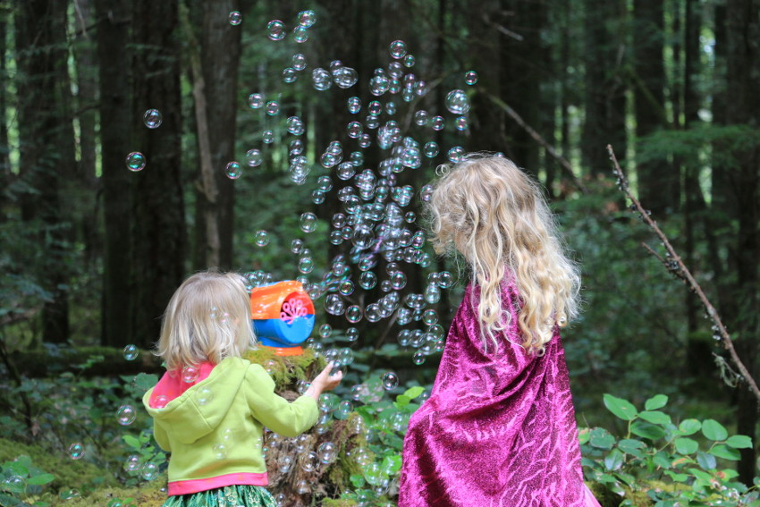 Two kids playing with bubbles